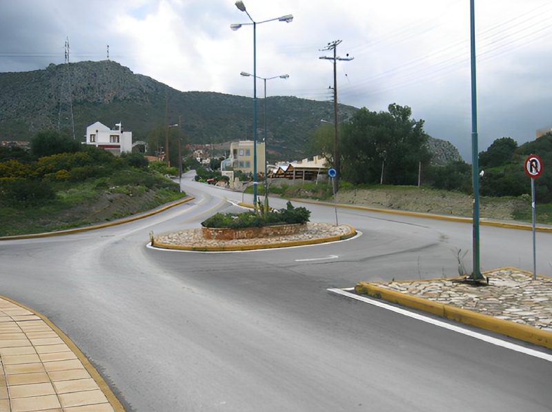 A street with many lights and trees on the side