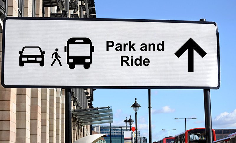 A sign that says park and ride with an arrow pointing to the right.