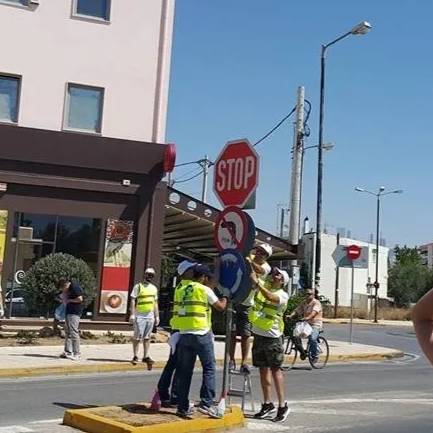 A group of people standing around on the side walk