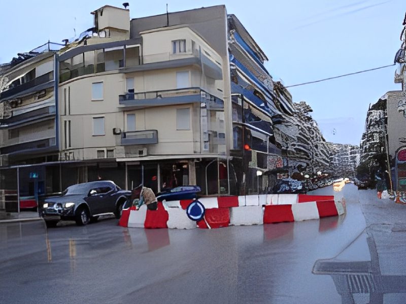 A street with red and white barriers blocking the road.