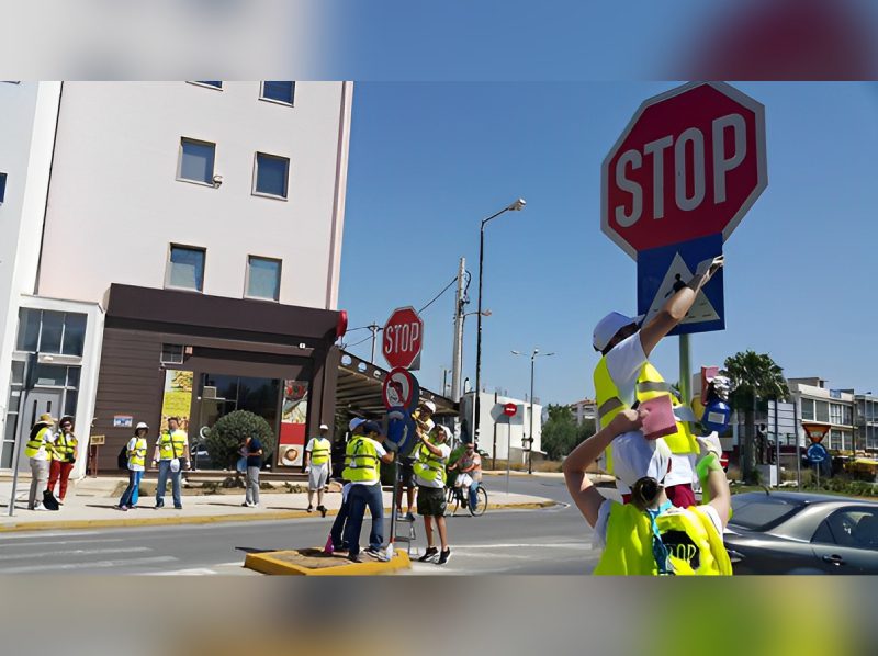 A group of people standing on the side walk