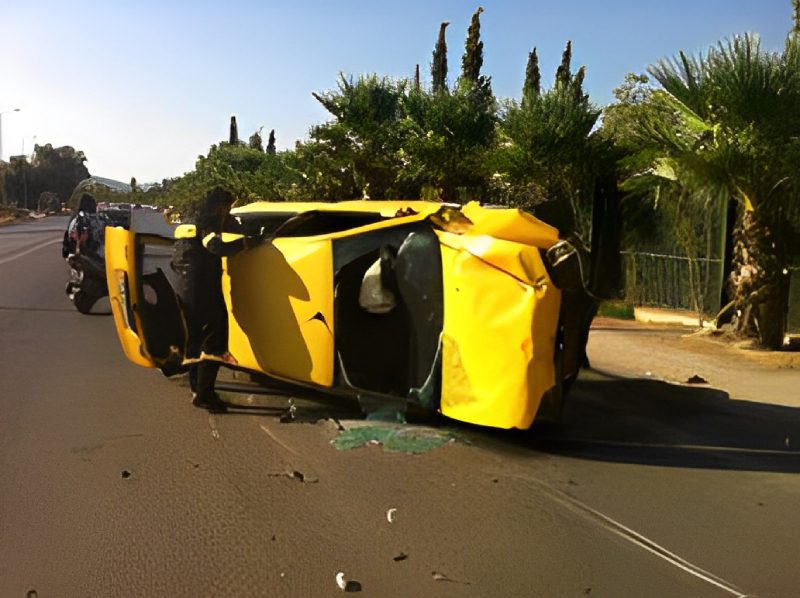 A yellow car that is sitting on the side of a road.