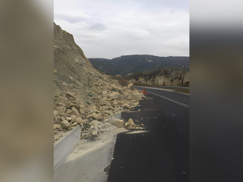 A road with some rocks on the side of it